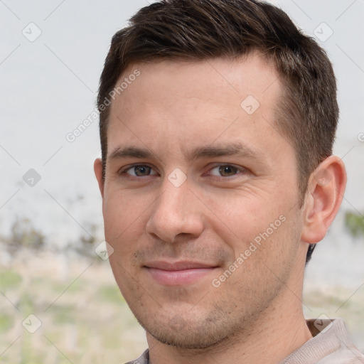 Joyful white young-adult male with short  brown hair and grey eyes