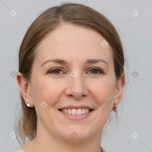 Joyful white young-adult female with medium  brown hair and grey eyes