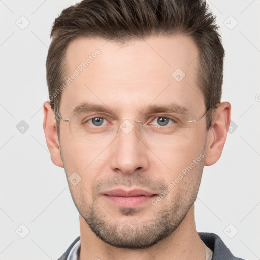 Joyful white young-adult male with short  brown hair and grey eyes