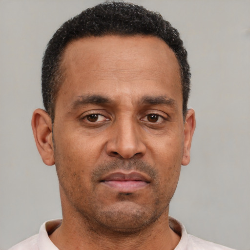 Neutral latino adult male with short  black hair and brown eyes