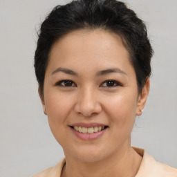 Joyful asian young-adult female with short  brown hair and brown eyes