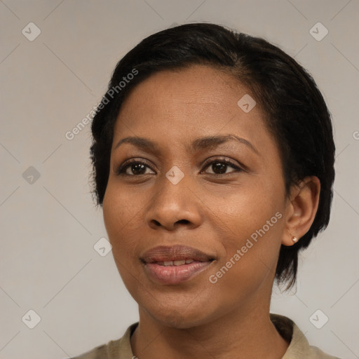 Joyful black young-adult female with short  black hair and brown eyes