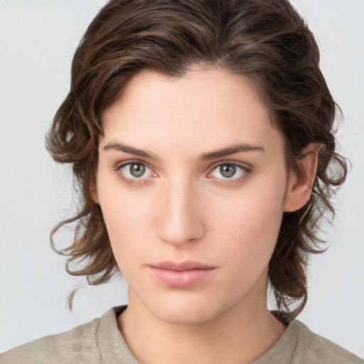 Neutral white young-adult female with medium  brown hair and grey eyes