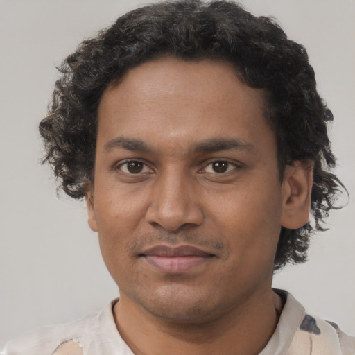 Joyful black young-adult male with short  brown hair and brown eyes