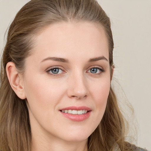 Joyful white young-adult female with long  brown hair and grey eyes