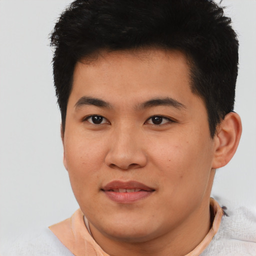 Joyful asian young-adult male with short  black hair and brown eyes