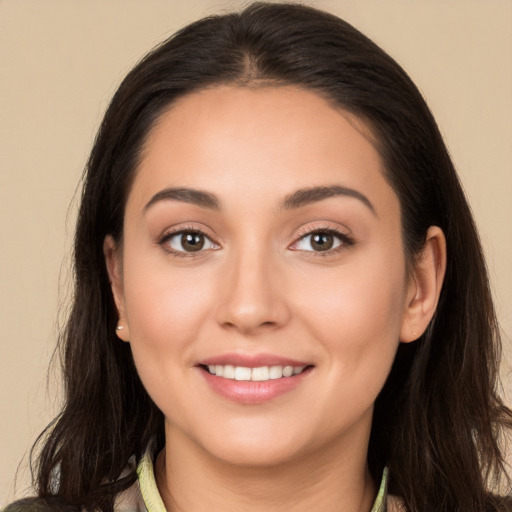 Joyful white young-adult female with long  brown hair and brown eyes