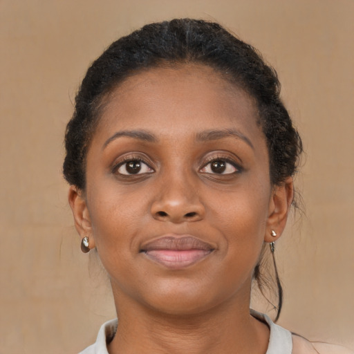 Joyful black young-adult female with short  brown hair and brown eyes