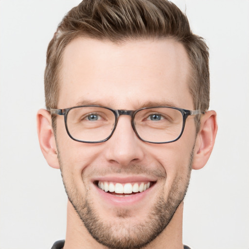 Joyful white young-adult male with short  brown hair and grey eyes