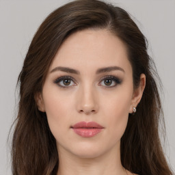 Neutral white young-adult female with long  brown hair and brown eyes