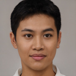 Joyful asian young-adult male with short  brown hair and brown eyes