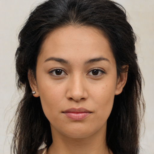 Joyful latino young-adult female with long  brown hair and brown eyes