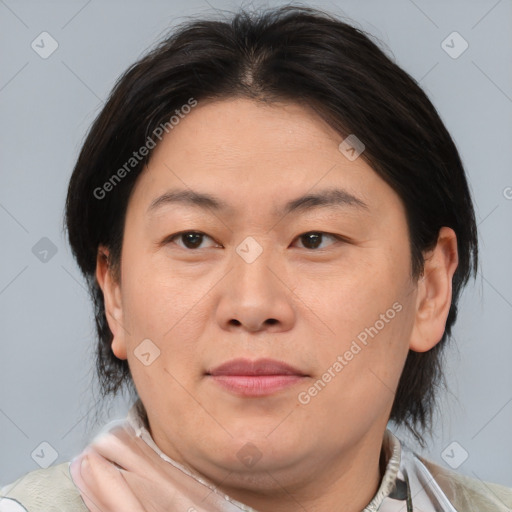 Joyful asian adult female with medium  brown hair and brown eyes