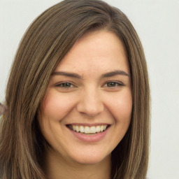 Joyful white young-adult female with long  brown hair and green eyes