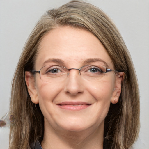 Joyful white adult female with medium  brown hair and blue eyes