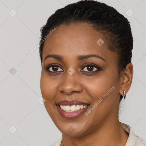 Joyful black young-adult female with short  black hair and brown eyes