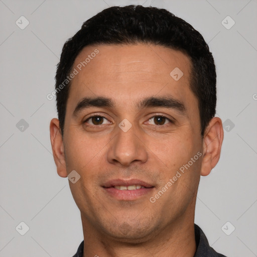 Joyful white young-adult male with short  black hair and brown eyes