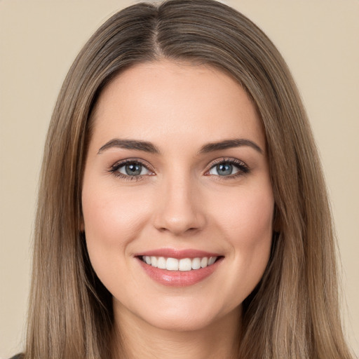 Joyful white young-adult female with long  brown hair and brown eyes