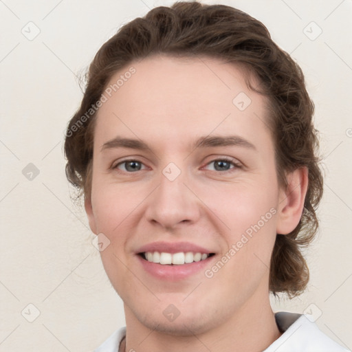 Joyful white young-adult female with short  brown hair and grey eyes