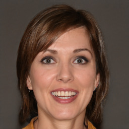 Joyful white young-adult female with medium  brown hair and blue eyes