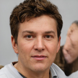 Joyful white adult male with short  brown hair and brown eyes