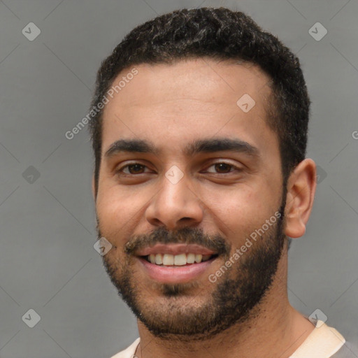 Joyful white young-adult male with short  black hair and brown eyes