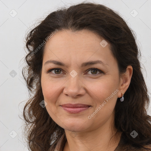 Joyful white adult female with long  brown hair and brown eyes