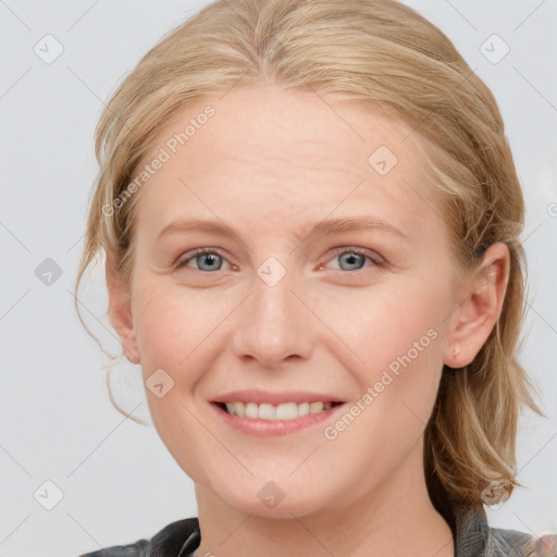 Joyful white young-adult female with medium  brown hair and blue eyes