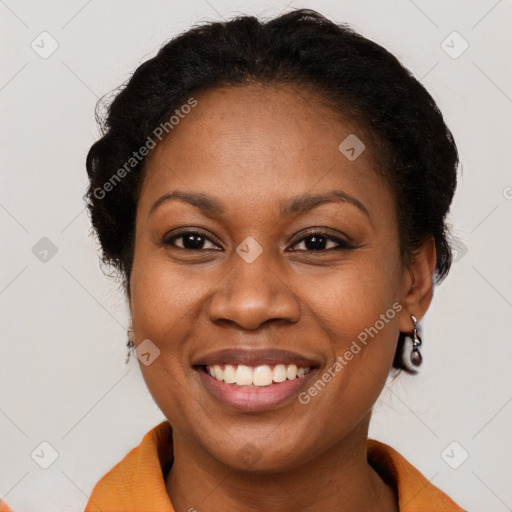 Joyful black adult female with short  brown hair and brown eyes