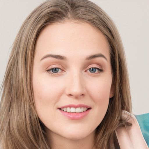 Joyful white young-adult female with long  brown hair and green eyes