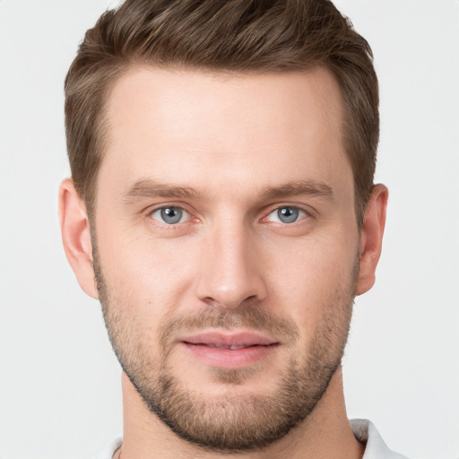 Joyful white young-adult male with short  brown hair and grey eyes