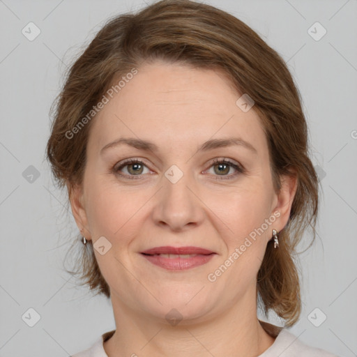 Joyful white adult female with medium  brown hair and grey eyes