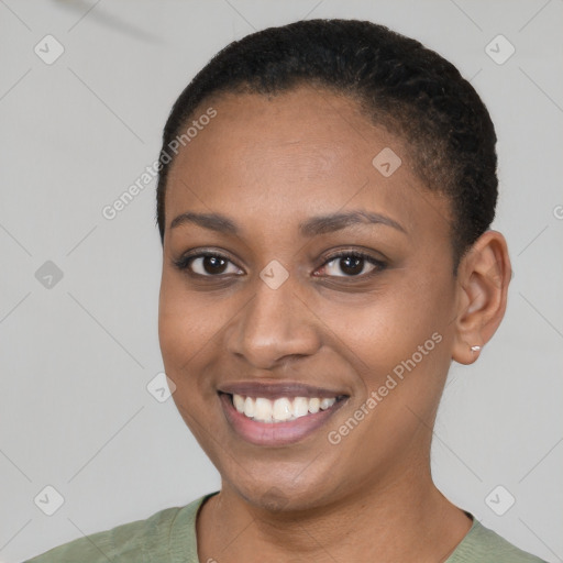 Joyful black young-adult female with short  brown hair and brown eyes