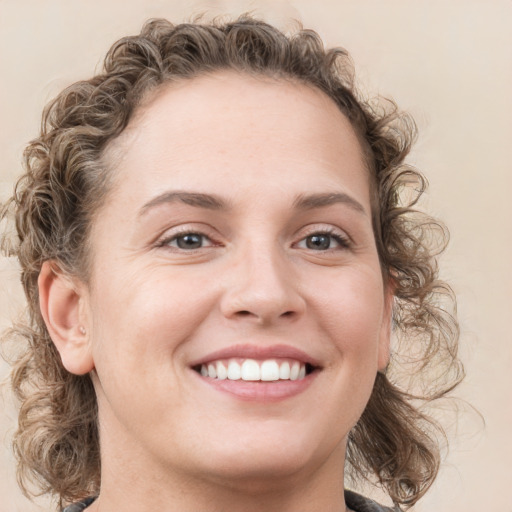 Joyful white young-adult female with medium  brown hair and blue eyes