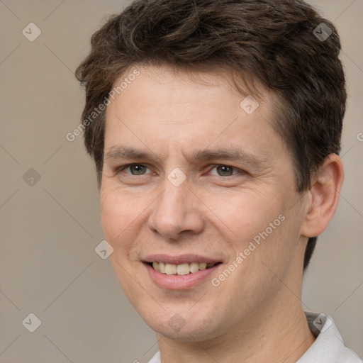 Joyful white adult male with short  brown hair and brown eyes