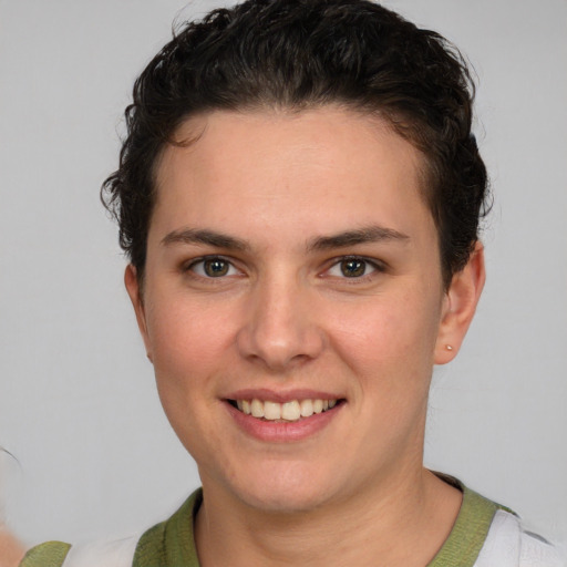 Joyful white young-adult female with short  brown hair and grey eyes