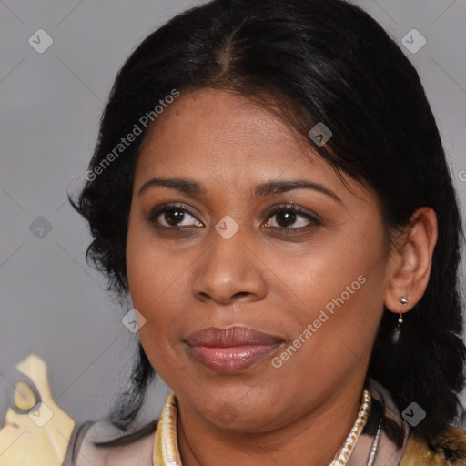 Joyful latino adult female with medium  brown hair and brown eyes