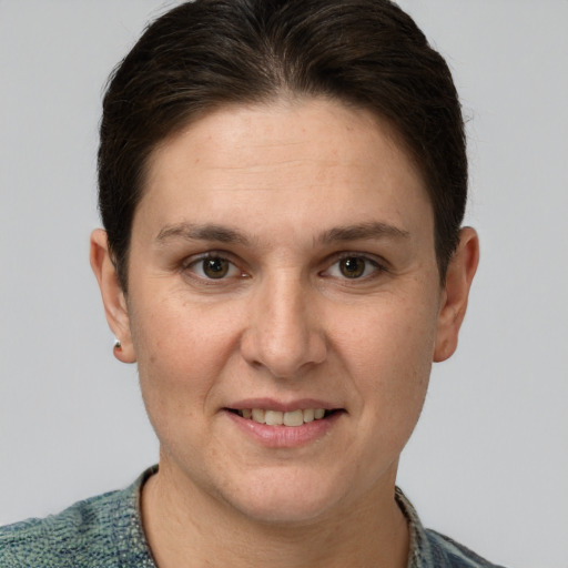 Joyful white adult female with short  brown hair and grey eyes