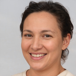 Joyful white adult female with medium  brown hair and brown eyes