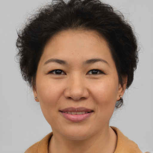 Joyful asian adult female with short  brown hair and brown eyes