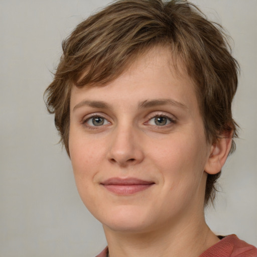 Joyful white young-adult female with medium  brown hair and green eyes