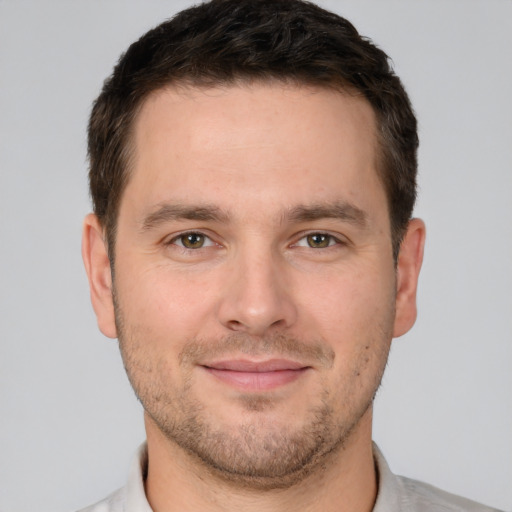 Joyful white young-adult male with short  brown hair and brown eyes