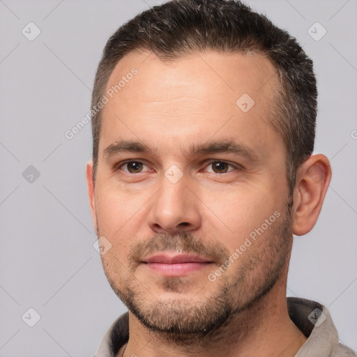 Joyful white adult male with short  brown hair and brown eyes