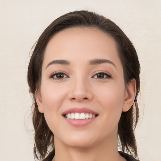 Joyful white young-adult female with medium  brown hair and brown eyes