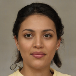 Joyful latino young-adult female with medium  brown hair and brown eyes