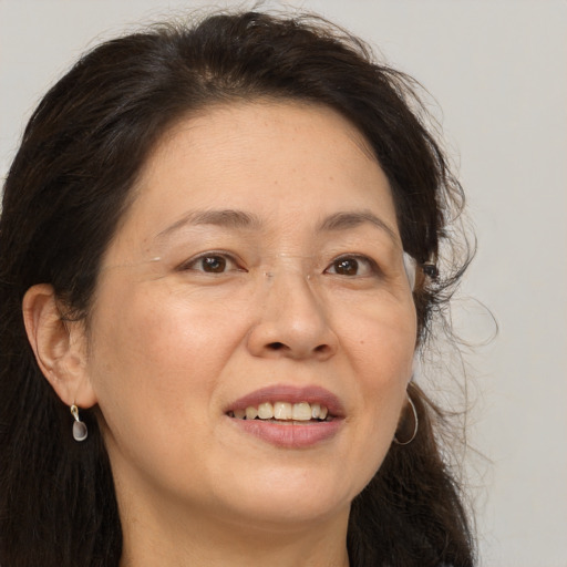 Joyful white adult female with long  brown hair and brown eyes