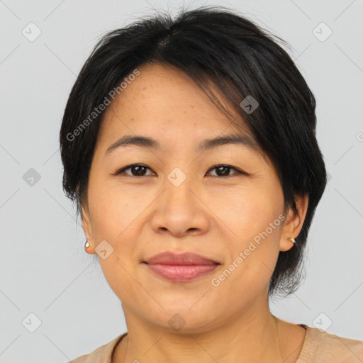 Joyful asian adult female with medium  brown hair and brown eyes