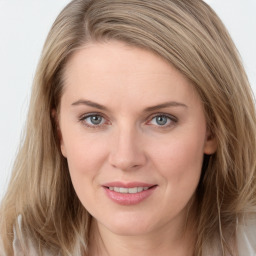 Joyful white young-adult female with long  brown hair and blue eyes