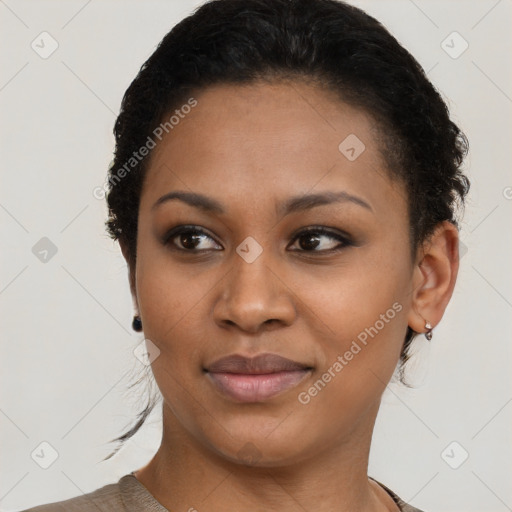 Joyful black young-adult female with short  brown hair and brown eyes