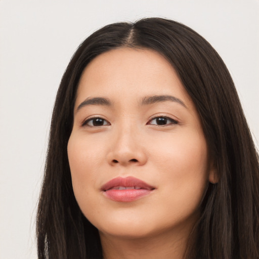 Joyful latino young-adult female with long  brown hair and brown eyes